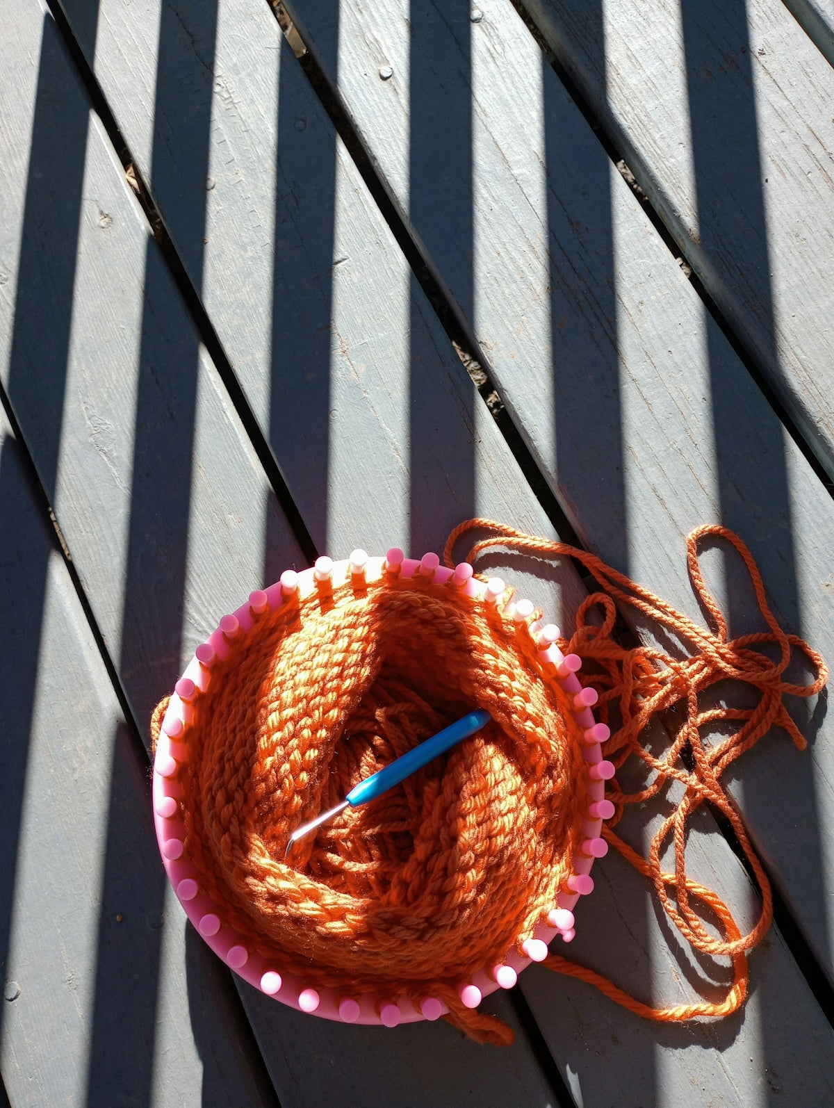 a crocheted bowl with a blue crochet hook