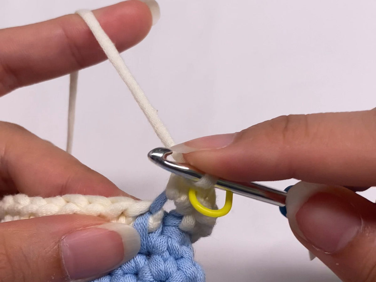 Slow, repetitive rounds of soft blue crochet in progress