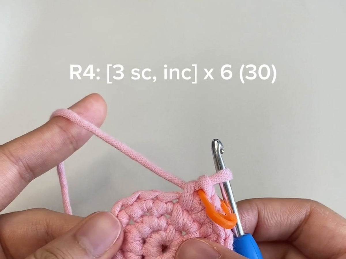 A round of pink crochet with the pattern line R4: [3 sc, inc] x 6 (30) shown above it
