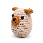 Yon Crochet Pug the Dog. Crocheted dog toy with brown ears and black eyes on a white background