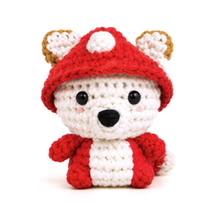 Button the Mushroom crochet plush, front view: a white amigurumi with a red spotted mushroom cap, gold and white ears and red arms