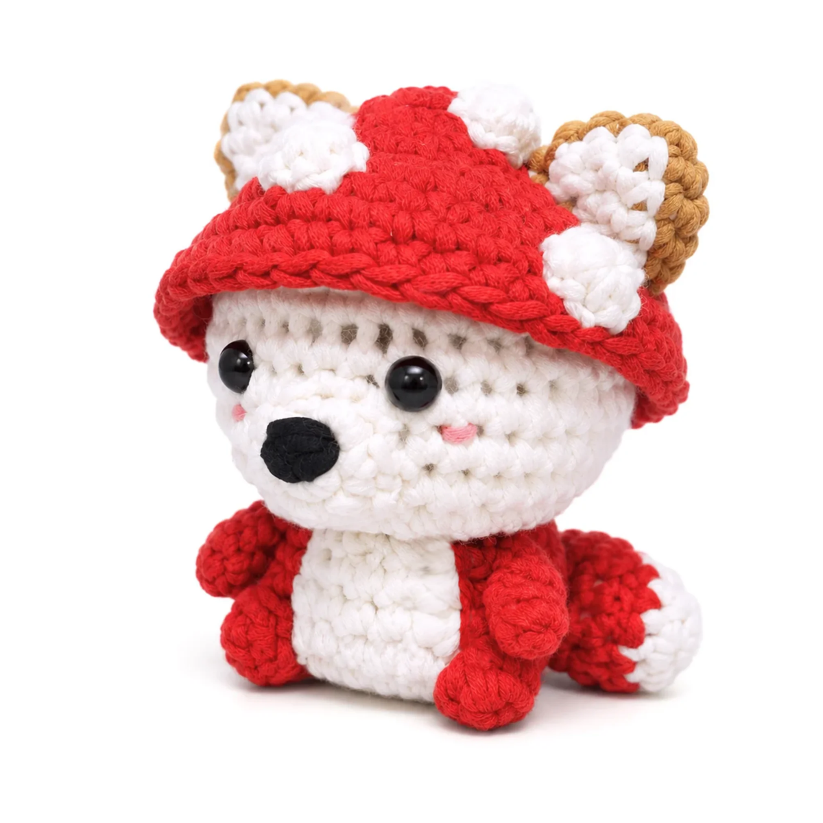 Button the Mushroom crochet plush at a three quarter angle, showing the brim of the red mushroom cap and the gold ears