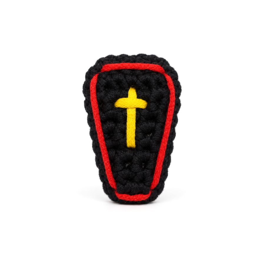 Black crochet coffin with a red border and a gold cross